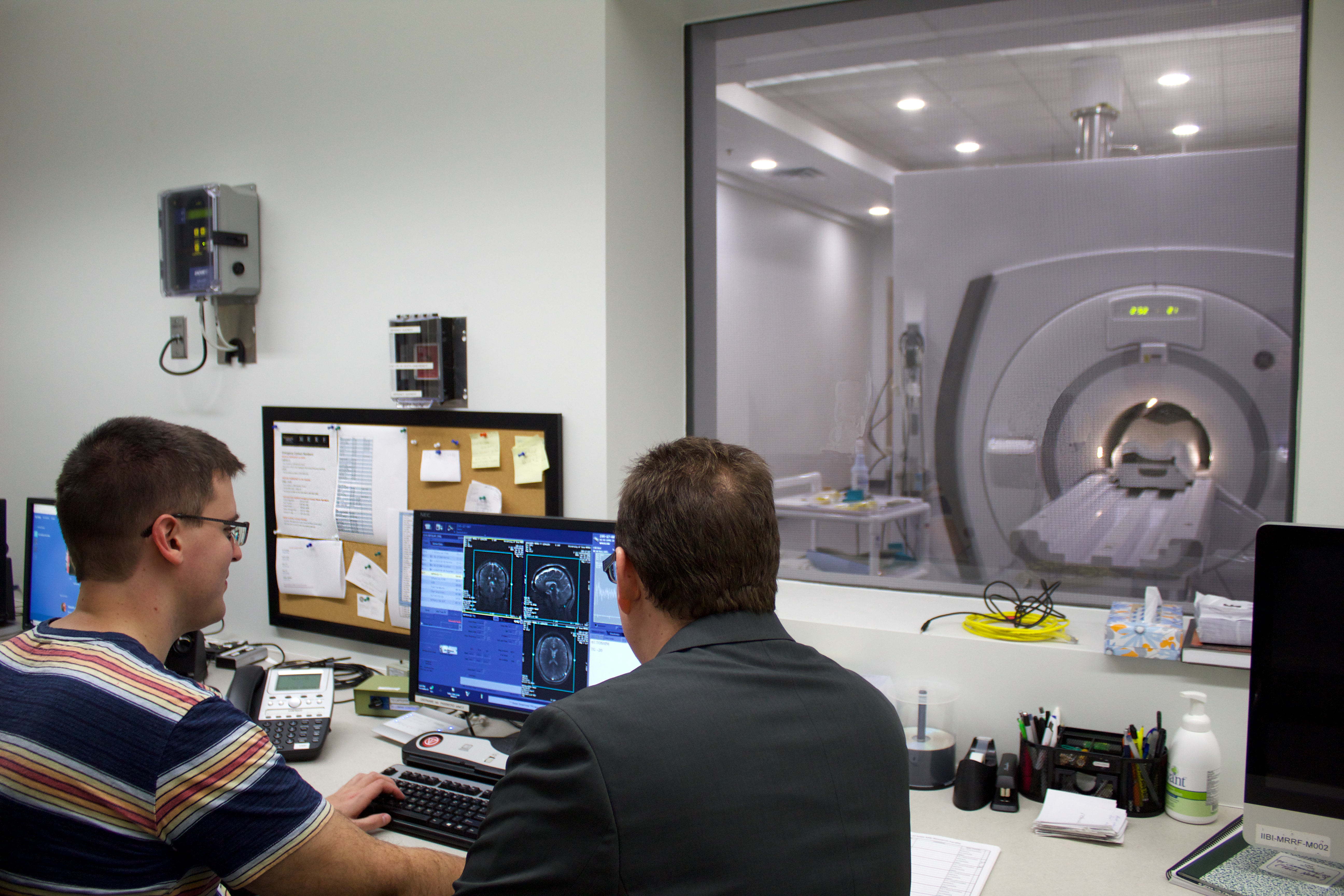 CBIG researchers viewing MRI scanner