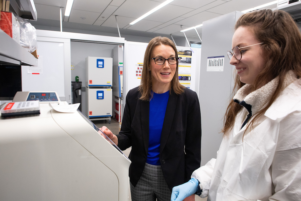 Kristan Worthington talks to a researcher in her lab