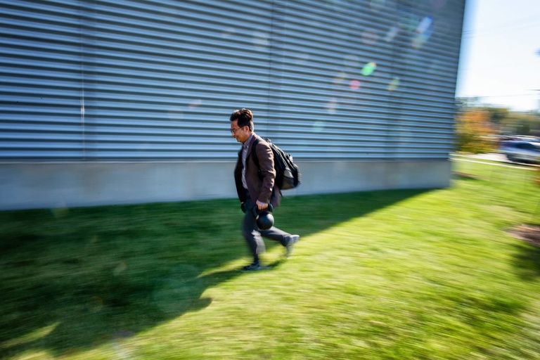 Person walking in front of the Engineering Research Facility