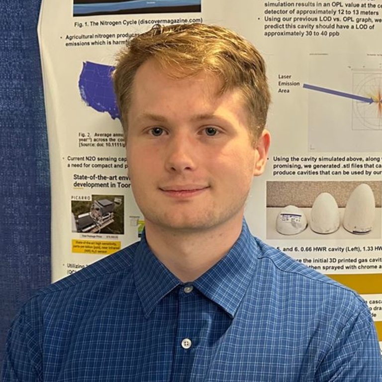 Tyler Nelson in front of his research poster