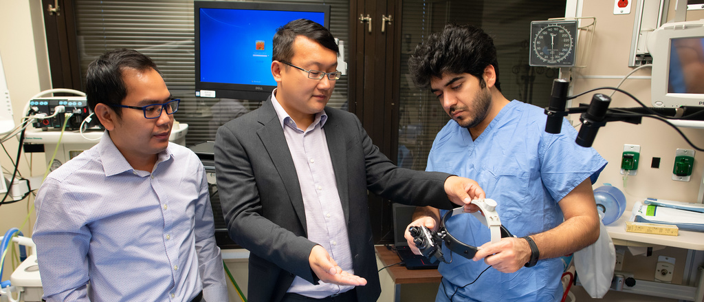 Researchers discussing Smart Goggles developed by Yang Liu's group