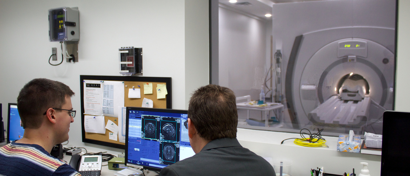 CBIG researchers viewing MRI scanner