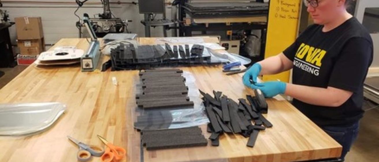 Student assembling face shields