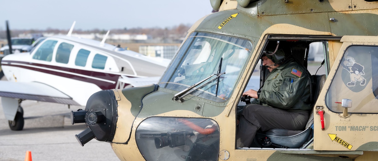 A pilot sits in a helicopter