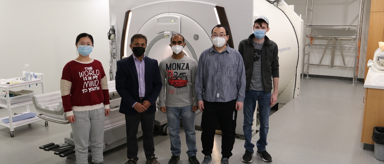 CBIG members standing in front of an MRI machine