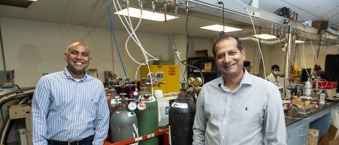 Suresh Raghavan and Syed Mubeen pose for a photo in a lab