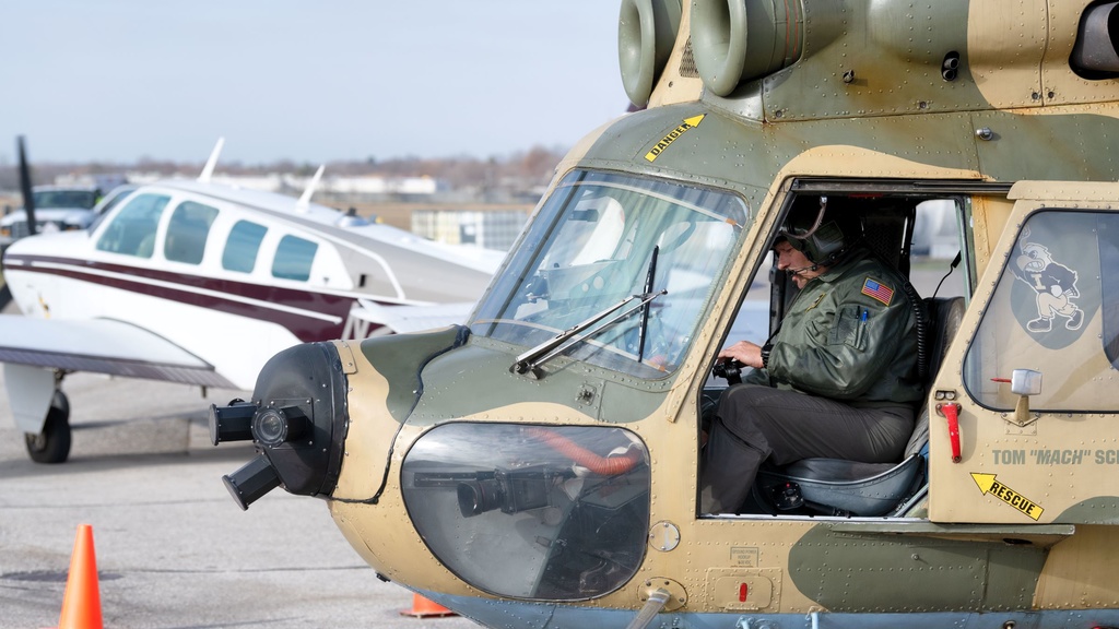 A pilot sits in a helicopter