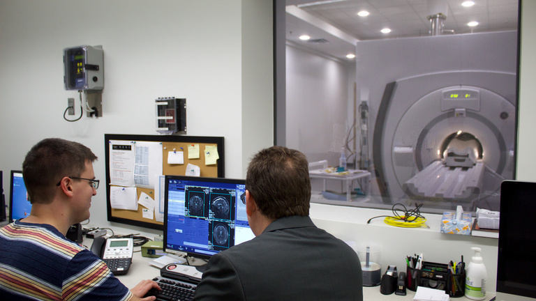 CBIG researchers viewing MRI scanner